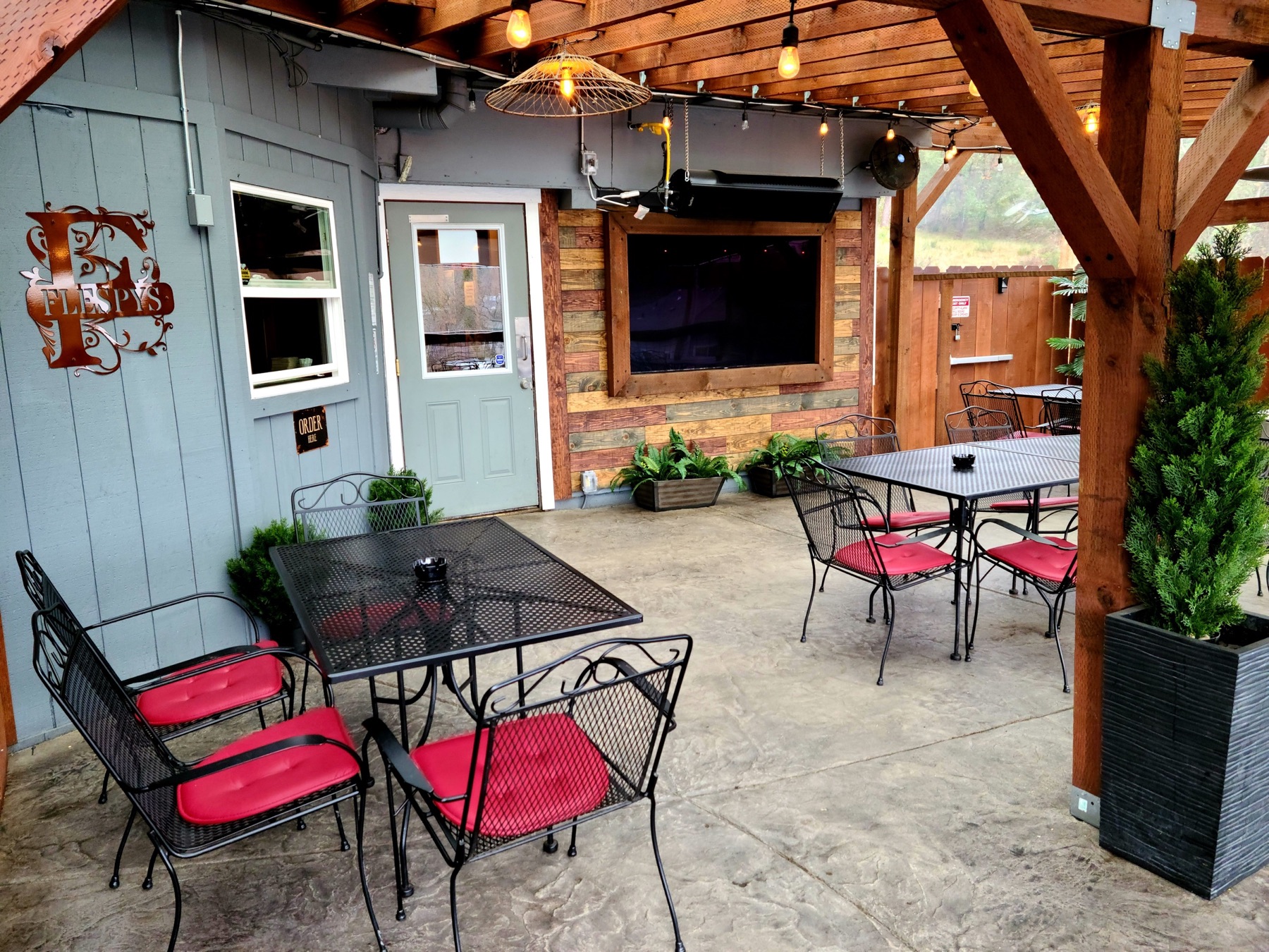 Covered patio seating and string lights at Flespy’s