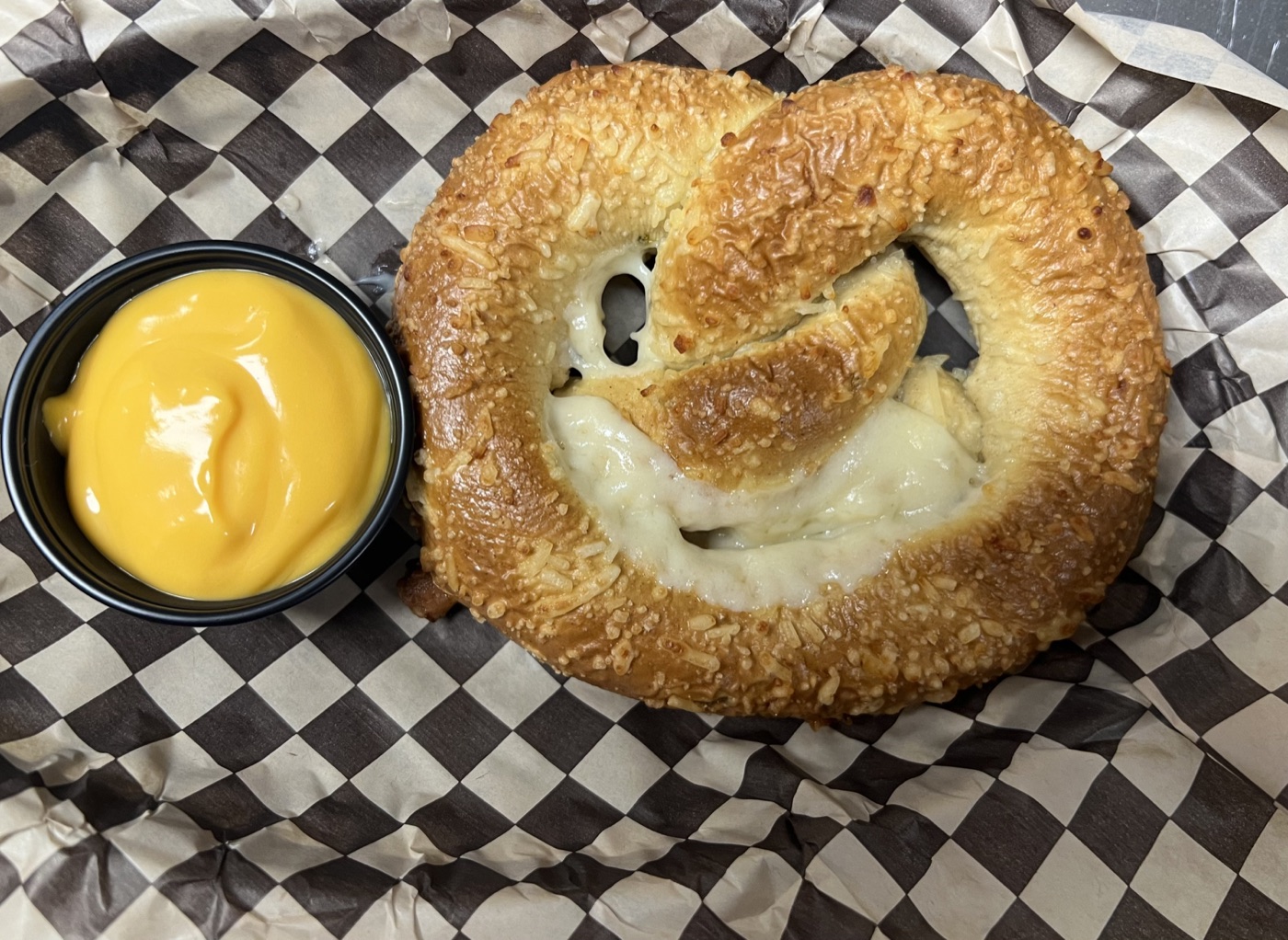 Cheese-filled soft pretzel with dipping sauce