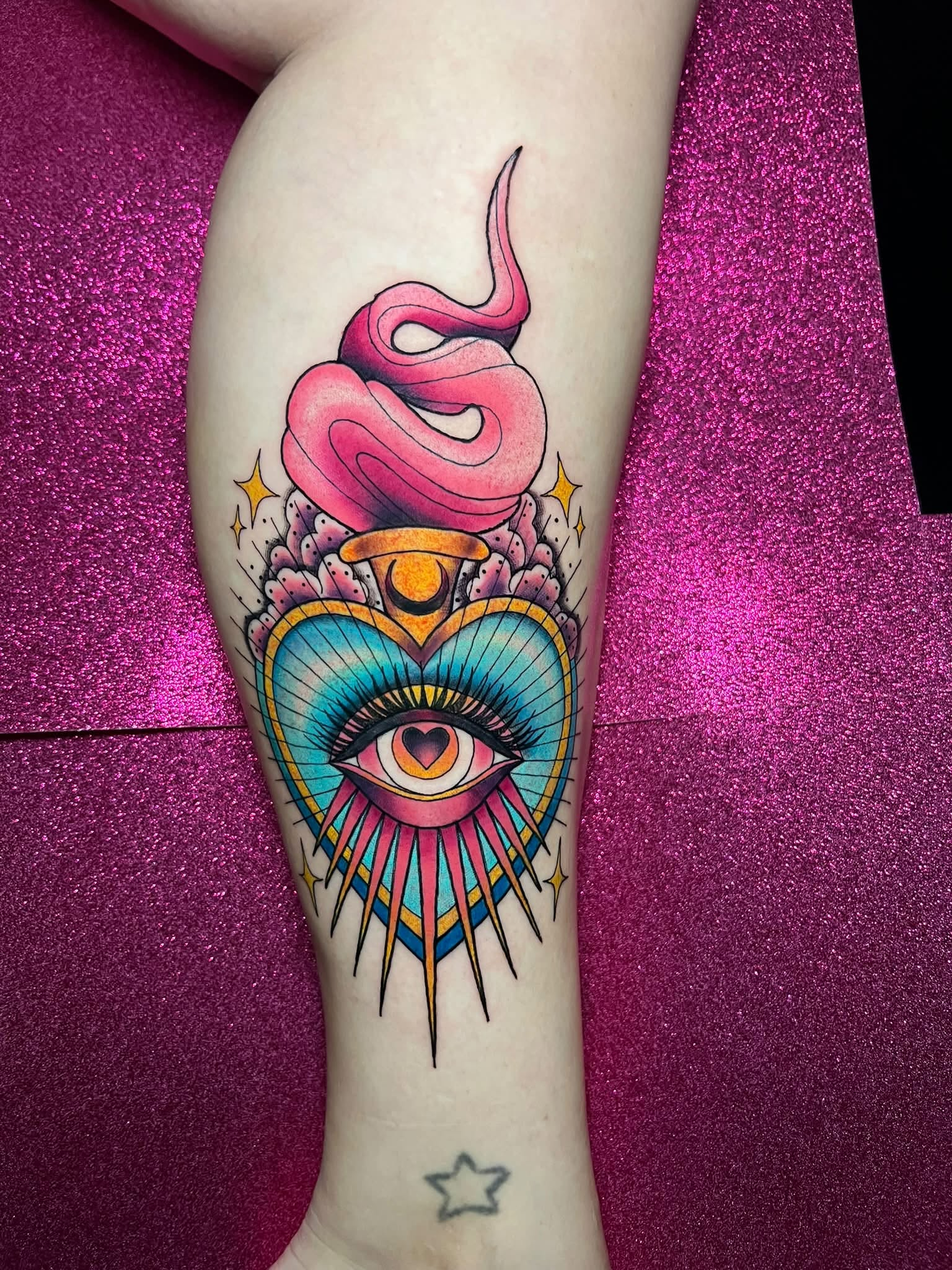 Eye, snake, heart, and celestial tattoo