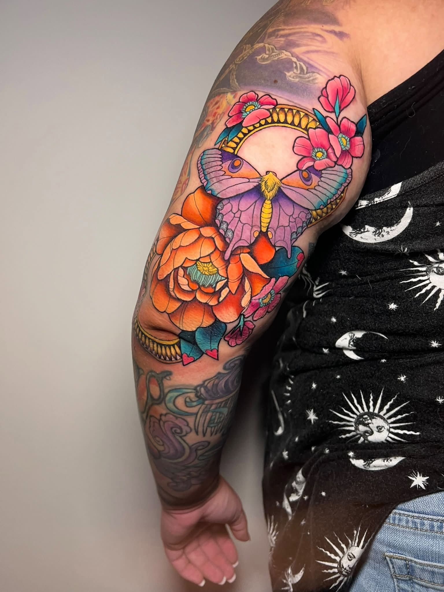 Colorful moth and flower tattoo